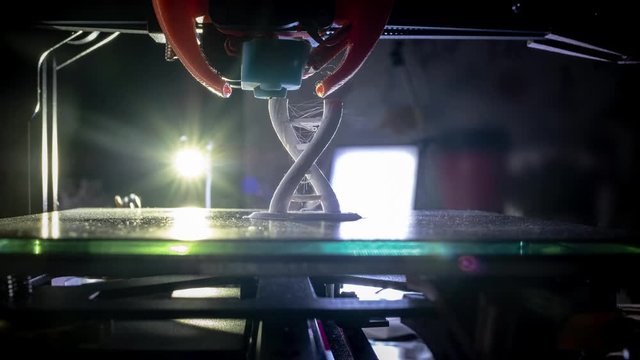 3D printer working. The 3d printer prints the dna structure from white abs plastic. Modern technologies in medicine and genetic engineering. 4K time lapse video