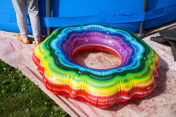 Multi-colored inflatable circle near the pool on a country plot