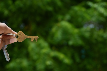 Man's hand with a key.  Home insurance concept.