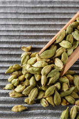 fragrant green cardamom on a wooden rustic background