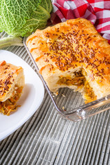 freshly baked cabbage pie on rustic wooden background
