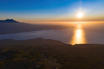 sunset with haze at the top of the Vicente Perez Rosales national park with view to the native forest, llanquihue lake and Calbuco volcano