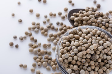 white peppercorns in glass bowl with spoon