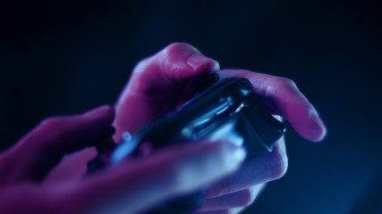 Playing video games close up with a black background