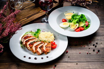 two course lunch grilled meat and fresh vegetable salad on the table
