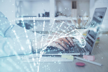 DNA hologram with businessman working on computer on background. Concept of bioengineering. Double exposure.