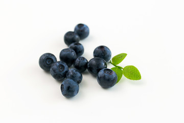 a handful of wild berries on a white table, blueberries