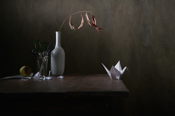 Paper crane and forced emigration. Still life.