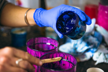 Female resin artist mixing pigment tint coloring