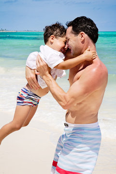 Father and son playing at the beach in the Caribbean