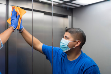 cleaning professional thoroughly disinfecting the elevator