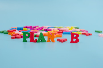 Business strategy and marketing concept, wooden letters with word plan b on blue background