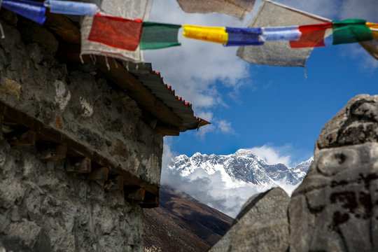 The summit of Mount Everest seen past prayer flags in Tengboche, Nepal