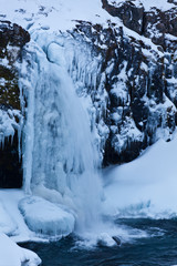 icicle and icy waterfall in winter iceland