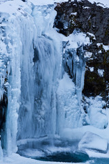 Fototapeta na wymiar icicle and icy waterfall in winter iceland