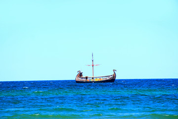 Fototapeta na wymiar Beautiful landscape with historic rook sailing on blue sea. Marine vessel