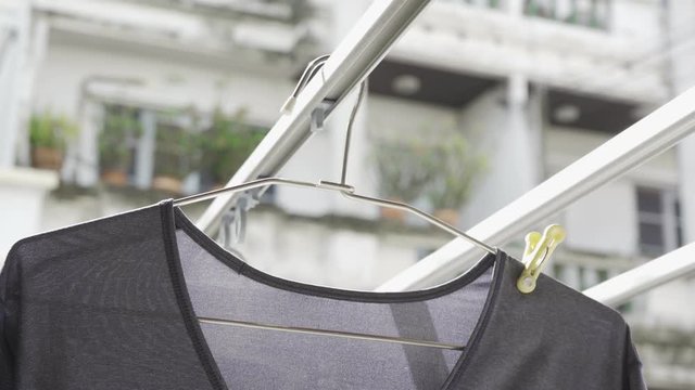 close up of a T-shirt on a clothes hanger on an outdoor clothes rack