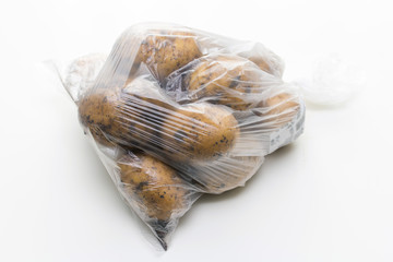 potato in a Plastic bag on white background
