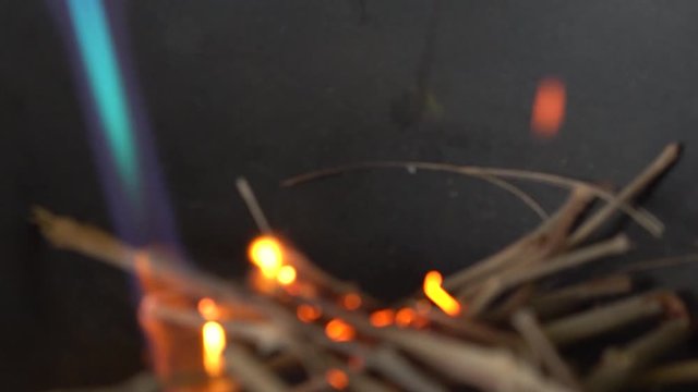 Chef lights wood with blowtorch for smoking process