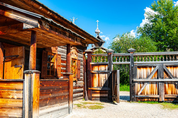 Traditional wooden peasant house (izba) in Siberian village	