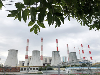 Cooling towers in the city. Boiler room. Industrial air pollution.