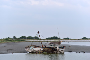 Fototapeta na wymiar Scrapped Fishing boats at Haje Port closed by the Saemangeum seawall in Okseo-myeon, Gunsan, North Jeolla Province, South Korea on the evening of August 24, 2020.