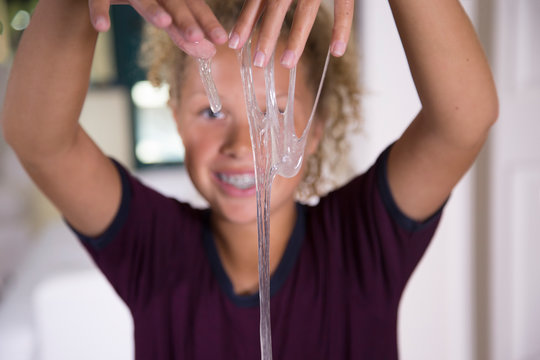 Smiling teen with transparent slime
