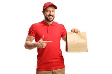 Food delivery man holding a paper bag and pointing