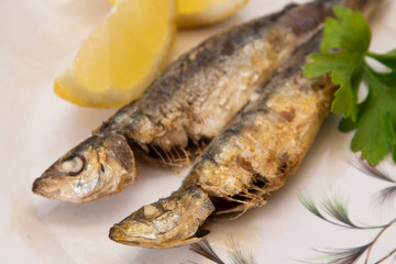 grilled sardines with lemon and parsley on the plate