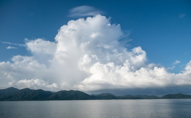 Fototapeta na wymiar White clouds floating over the islands of the sea