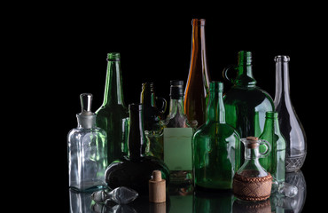 A group of colored, glass bottles on a black isolated background