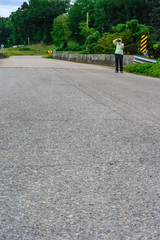 woman walking on the road taking photos