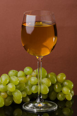 Glass with white wine and grapes. Still life
