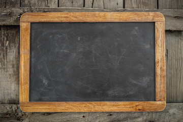Fototapeta na wymiar blank blackboard on wooden background