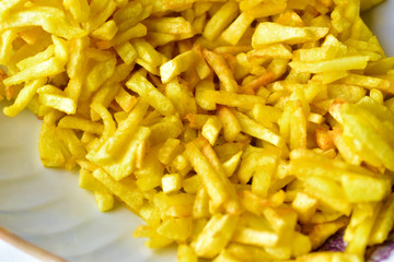 Freshly fried delicious French fries on a white plate
