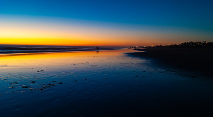 Sunset on an infinite beach in Cadiz, Spain