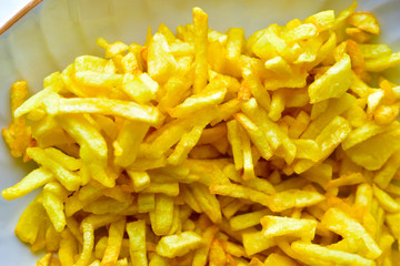 Freshly fried delicious French fries on a white plate