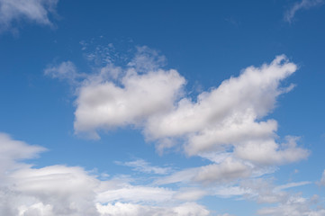 Naklejka na ściany i meble fluffy white clouds against a blue sky.