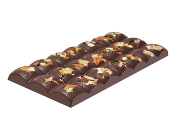 Bar of milk chocolate with raisins and dried apricots on a background of cinnamon sticks close-up