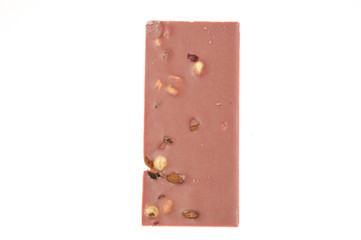 Bar of pink chocolate with raisins and fruits close-up