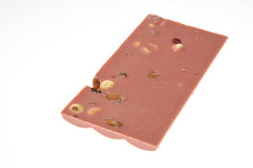 Bar of pink chocolate with raisins and fruits close-up