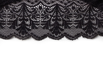 Black lace texture with flowers on a white background. Background of black lace with a flower pattern on a white background. Black guipure. Black fabric with an ornament