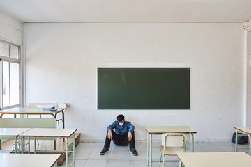 Stressed teacher in the classroom.