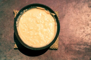 Top View of Curd or Dahi (Yogurt) in a Soil Bowl Isolated in Rough Surface, Also Known as Doi