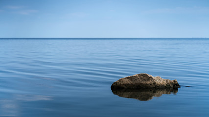 Natural stone in the sea on a clear day.