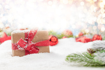 Fototapeta na wymiar Christmas greeting card with gift box in snow