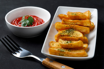 fried potatoes with salt, parsley and rosemary
