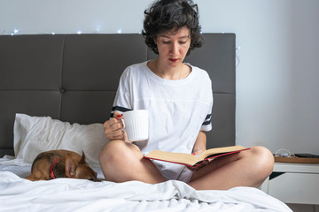Woman reading and drinking coffee