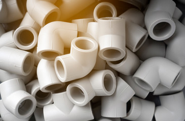 Grey pvc plumbing pipes corners background closeup