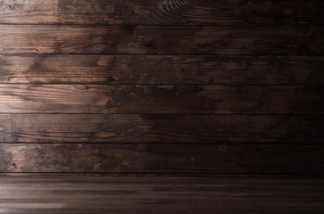 Naklejka premium Textured wooden background from dark planks, empty wooden table at the bottom.